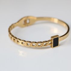 This bracelet is lightweight and easy to wear, and lend a modern edge to your jewelry wardrobe. It goes well with our BLACK GEMSTONE RING. Material: 316L Stainless Steel, 18k Gold Plated Size: 6"-7.5" Origin: California, USA Each product packed with SOCALI premium pouch and box, together with silver cleaning cloth and card. Material Our products are made from the top-grade 316L stainless steel - a metal that is nickel-free and does not fade or blacken and 100% hypoallergenic for the benefit of t Luxury Bangle With Stone Setting As Gift, Luxury Black Gold Bracelet In Classic Style, Luxury Gift Bangle For Men, Luxury Modern Black Bangle, Luxury Modern Black Bracelet, Luxury Black Bracelets For Everyday Luxury, Classic Luxury Black Gold Bracelet, Luxury Adjustable Black Bangle, Luxury Classic Black Gold Bracelet