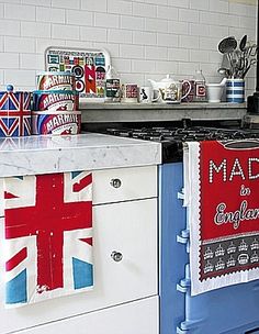 the kitchen is decorated with british flags and tea towels