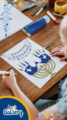 a young child is drawing on paper with markers