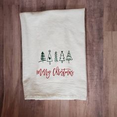 a white towel with merry christmas trees on it