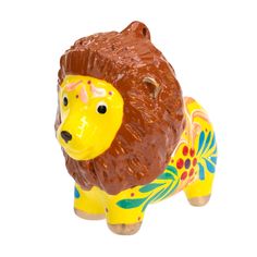 a ceramic lion figurine is shown against a white background with an orange mane