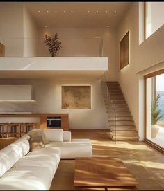 a living room filled with white furniture and lots of windows