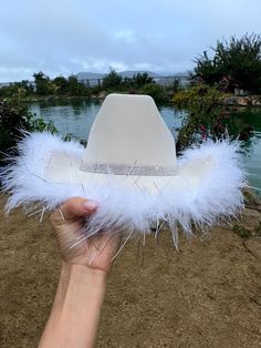 "Rhinestones lined the bottom brim and the crown.  Feathers line the brim.  This is one size fits most, there's a drawstring to adjust sizing.  ships in 2 business days! Stunning in person  Perfect for Halloween , Barbie costume, Coachella , stagecoach, Nashville, country concerts, bachelorette parties, brides, weddings Please note that the hats are handmade and may have some variances and blemishes. If any, they are very minor . The hats might have a bit of \"stickiness\" from the glue setting Parisian Cowgirl, Halloween Barbie Costume, Boujee Cowgirl, Cowgirl Costume Halloween, Rhinestone Cowgirl Hat, Queen Of Hearts Halloween, Halloween Barbie, Nashville Country, White Cowboy Hat