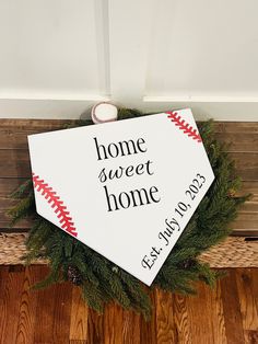 a home sweet sign with a baseball on it