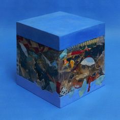 a blue box that has many different things in it and is covered with glass shards