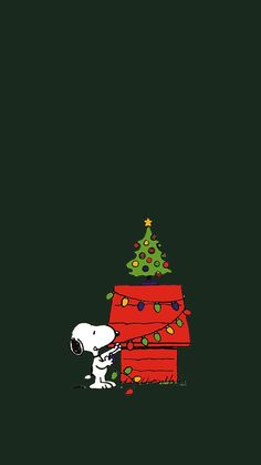 a charlie brown christmas tree on top of a red box with a snoop bear sitting next to it