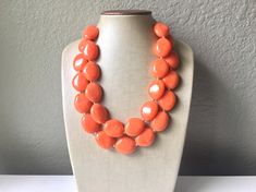 "A classic color that never goes out of style! Each bead is one of a kind, and has swirls of multi-toned oranges and white. Each bead has a \"stained glass\" look - very chic and elegant. This is part of our \"Praline Necklace Collection\". Love this style but prefer a different color? Check out the rest of the collection here: https://www.etsy.com/shop/PolkaDotDrawer/search?search_query=Praline 16 inches long with a 4 inch extender chain. Thank you for supporting handmade and small American bus Elegant Orange Beaded Necklaces For Party, Elegant Orange Beaded Necklace For Party, Formal Orange Single Strand Necklace, Orange Round Beads Party Jewelry, Orange Party Necklaces With Large Beads, Orange Round Beads Jewelry For Party, Elegant Orange Necklace For Party, Elegant Orange Necklaces With Polished Beads, Orange Necklaces With Large Beads For Party