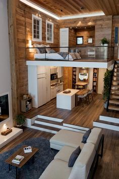 a living room filled with furniture and a fire place in the middle of a room