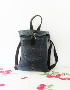 Denim mini backpack bags have many every day uses. A strong denim backpack is great for every day use. They are large enough for iPads, wallets, keys, phones, or anything that you carry on a regular basis! The denim is dark blue with matching pocket, straps, and handle The top folds over and is held closed with a hook The measurements for this denim backpack are 12" tall and 8" wide at the top and 8.5" wide at the bottom The two adjustable straps are 12" to 22" The handle is 10" 100% machine washable! I call my new line of denim products Nothing Fancy. Each item is made from recycled denim jeans. They are very basic, nothing fancy added but very well made. Each seam is double stitched with zig-zag to prevent unraveling. Yes, I could line them or add a fancy belt but I wanted to keep it sim Denim Backpack, Upcycled Denim, Recycled Denim, New Line, Denim Mini, Mini Backpack, Zig Zag, Backpack Bags