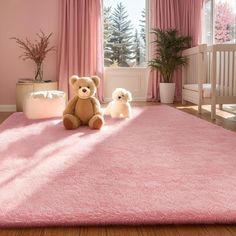 two teddy bears are sitting on a pink rug