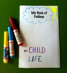 two crayons are sitting on top of a piece of paper with the words, my book of feelings by child life