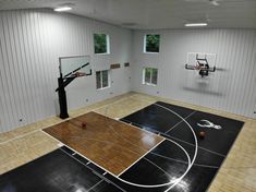 an indoor basketball court is shown in this image, with the hoop on the wall