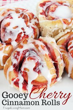 some cinnamon rolls are on a plate with icing