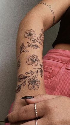 a woman with a flower tattoo on her arm