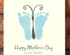 a card with the words, happy mother's day love, and two footprints on it