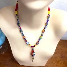 Indulge in the charm of vintage fashion with this beautiful Milifiori glass beaded necklace. The easy-on toggle clasp ensures convenience while the upscale, bright, and bold design showcases quality hand-blown glass bead craftsmanship. Measures 17" in length, pendant drops 2" and is 3/8 round. In new condition without any wear. Gifts for girlfriend, gift for BFF, gifts for Amon, fashionista gifts, eclectic gifts, fashion costume jewelry, contemporary jewelry. Colorful Adjustable Glass Beaded Necklaces, Artisan Multicolor Glass Beaded Necklaces, Eclectic Adjustable Multicolor Beads, Multicolor Glass Beaded Necklace For Festivals, Bohemian Multicolor Murano Glass Necklaces, Multicolor Murano Glass Beaded Necklace, Bohemian Multicolor Murano Glass Necklace, Bohemian Murano Glass Beads, Colorful, Bohemian Colorful Murano Glass Beads