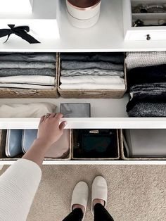 a person standing in front of a closet filled with clothes