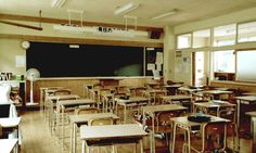 an empty classroom with desks and chairs