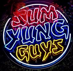 a neon sign that says yummy guys on it