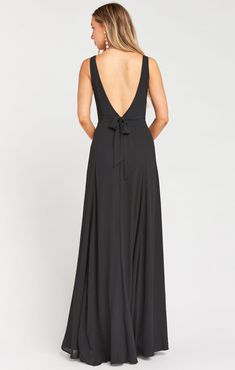 the back of a woman wearing a black dress