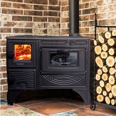 a black stove top oven sitting next to a stack of logs