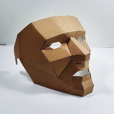 an origami mask made out of cardboard