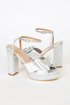 The Lulus Lilsa Silver Metallic Bow Platform Ankle Strap Heels are here to bring a perfect party look! Crinkle textured metallic fabric shapes these glam heels that have an open toe and crisscrossing straps that tie together at a large bow. A matching strap wraps around and secures above the ankle with a silver buckle. Trendy 0.75"" toe platform. Block heel. 4. 25" wrapped block heel. Cushioned insole. Felted rubber sole has nonskid markings. Man made materials. Imported. Lulus | Lilsa Silver Me Platform Ankle Strap Heels, Heel With Bow, Glam Heels, Silver Metallic Heels, Twisted Ankle, Trendy High Heels, Cute High Heels, Heels Prom, White High Heels