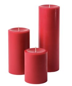 three red candles sitting next to each other