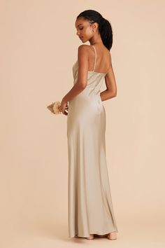 the back of a woman wearing a champagne colored gown