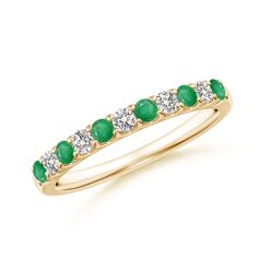 a yellow gold ring with emeralds and diamonds