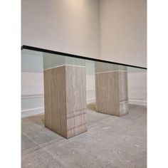 two glass and stone pedestals in an empty room