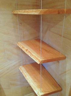 a wooden shelf with clear glass shelves on it