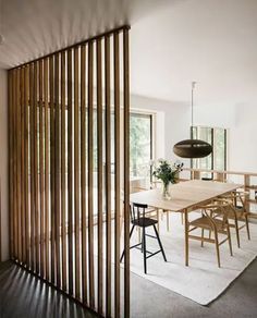 a dining room with wooden slats on the wall