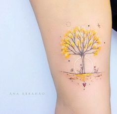 a woman's leg with a tree tattoo on the left side of her thigh