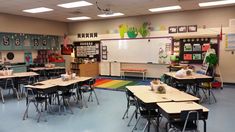 an empty classroom is shown with desks and chalkboards on the whiteboard wall