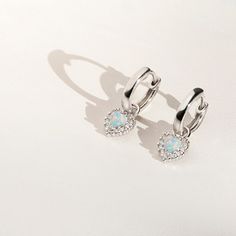 You will fall in love with the pretty details on these huggie hoop earrings for little girls. Crafted with the finest 925 sterling silver, and featuring delicate heart shaped stone at the center with clear cubic zirconia surrounding it; these earrings make for a great gift for someone special. Order this lovely pair for your little angel today and we'll include a sweet little gift box. White Gold Huggie Heart Earrings Gift, Silver Huggie Earrings With Heart Charm For Gift, Nickel Free White Sterling Silver Huggie Earrings, Dainty Silver Huggie Earrings, Silver Huggie Earrings For Gift, Silver Huggie Earrings With Heart Charm For Anniversary, Silver Huggie Earrings For Valentine's Day Elegant Style, Sterling Silver Huggie Birthstone Jewelry, Dainty Sterling Silver Huggie Earrings