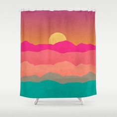 a colorful shower curtain with mountains and the sun in the sky over water at sunset