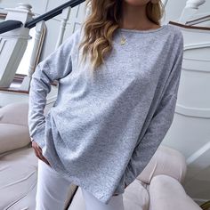 The EMES SHOP sweatshirt is detailed with a casual boat neck line that can be worn as one shoulder. Features a drop shoulder. solid color. long sleeves. and an oversized fit. Pair it with white trousers and heels for an easygoing look.MATERIAL:100% Soft Poly MEASUREMENTS:Product Length 25"-27"in Small | Bust & Hem Width : 44"-46"in Medium| Bust & Hem Width : 46"-48"in Large| Bust & Hem Width : 48"-50"in XL| Bust & Hem Width : 50"-52"in Women Wholesale, Women Long Sleeve Tops, Casual Tops For Women, Basic Tops, Shop Sweatshirts, Top Women, Grey Long Sleeve, Boat Neck, Long Tops