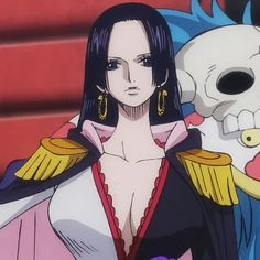 a woman with long black hair standing next to a skull and wearing large gold earrings