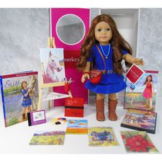 the doll is standing next to her art supplies