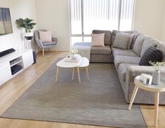 a living room filled with furniture and a flat screen tv