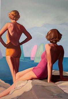 two women in bathing suits are sitting on the rocks by the water and looking at sailboats