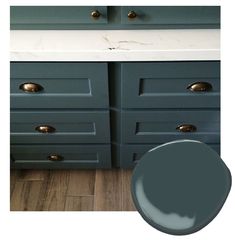 an image of a bathroom with blue cabinets and white counter tops in the same color