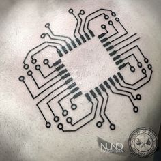 the back of a man's chest with an electronic circuit tattoo on it