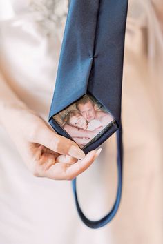 a person holding a blue tie with a picture on it