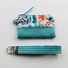 two zippered pouches sitting next to each other on top of a white table