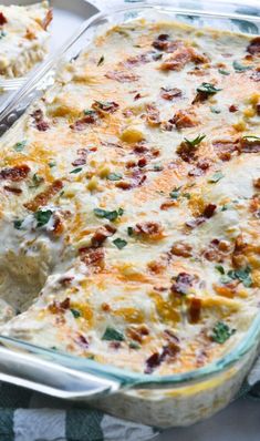 a casserole dish with meat and cheese in it on a checkered cloth