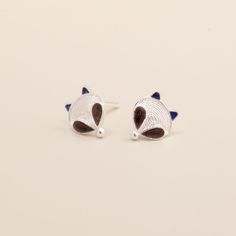 Discover the perfect blend of traditional craftsmanship and whimsical charm with our Fox Cloisonné Enamel Stud Earrings. These unique studs showcase the intricate beauty of Chinese Cloisonné artistry on a luxurious S999 silver base. Key Features: - Exquisite Cloisonné Technique: Each earring features vibrant enamel work, bringing the playful fox design to life. - Premium S999 Silver Base: Crafted with high-purity silver for lasting quality and shine. - Filigree Artistry: Delicate filigree detail Traditional Hand Painted Sterling Silver Jewelry, Adjustable Animal Design Earrings As Gift, Whimsical Hand Painted Silver Earrings, Unique Studs, Fox Face, Enamel Stud Earrings, Fox Design, Silver Fox, Cloisonne Enamel