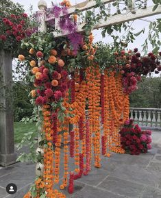 an outdoor area with flowers hanging from the ceiling