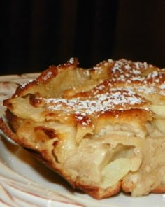 a white plate topped with food covered in powdered sugar